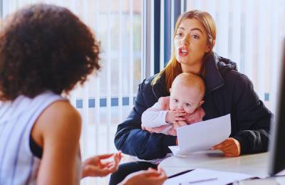 mother with baby complaining to agent